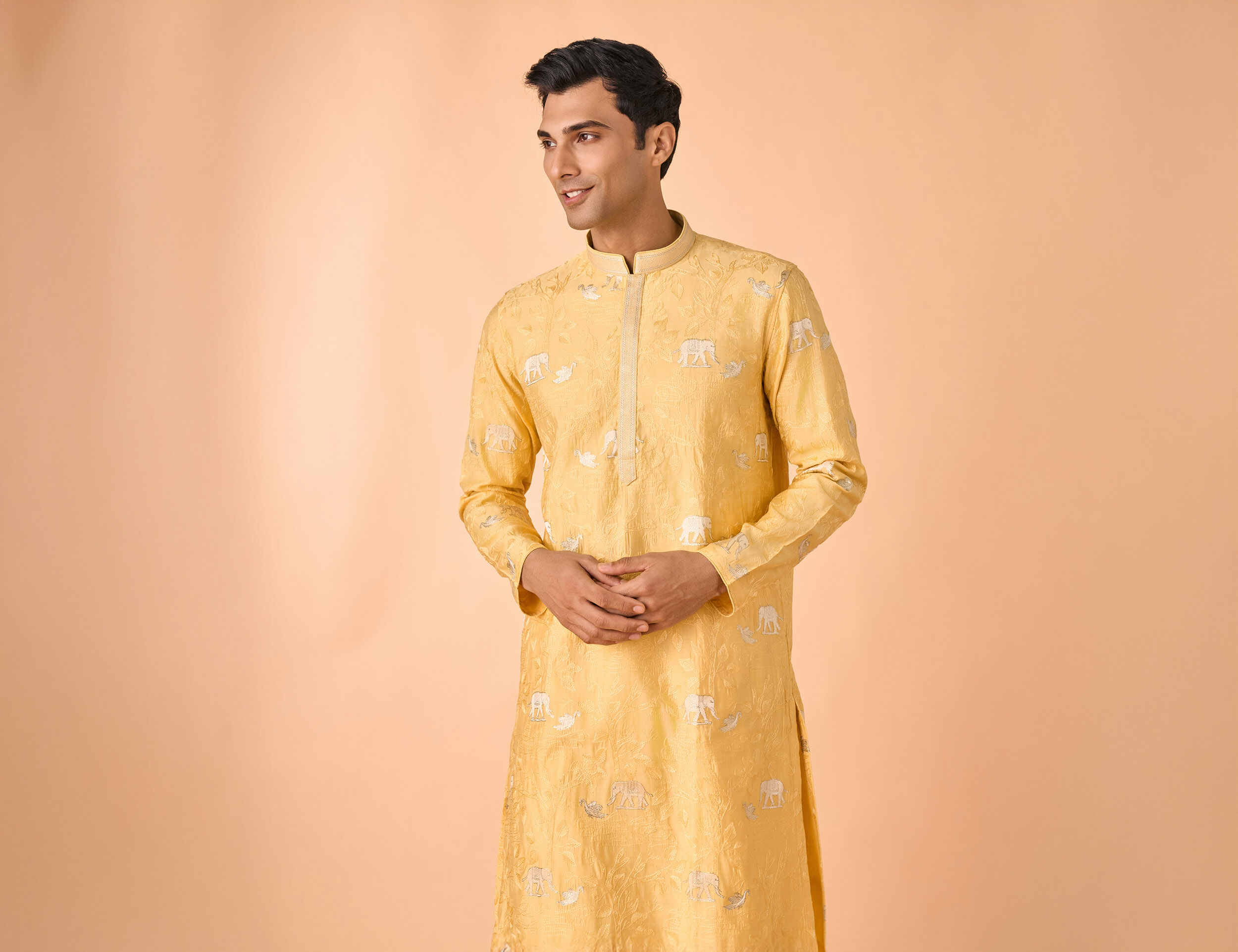 Man wearing yellow embroidered kurta for Diwali festive traditional outfit